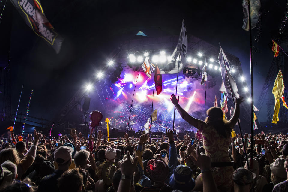 Festival goers watch Paul McCartney perform at Glastonbury Festival in Worthy Farm, Somerset, England, Saturday, June 25, 2022. (Photo by Joel C Ryan/Invision/AP)