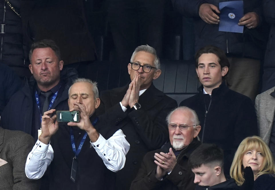 Soccer broadcaster Gary Lineker, centre, gestures, during the English Premier League soccer match between Leicester City and Chelsea at the King Power Stadium, in Leicester, England, Saturday March 11, 2023. (Mike Egerton/PA via AP)