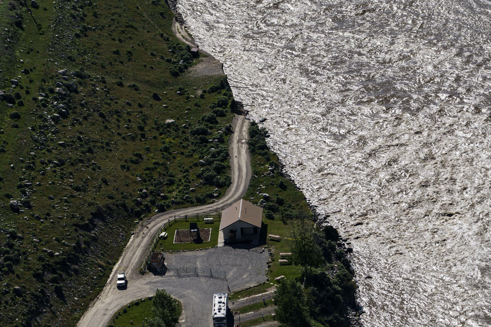 FILE - A road ends where floodwaters washed away a house in Gardiner, Mont., on June 16, 2022. As cleanup from historic floods at Yellowstone National Park grinds on, climate experts and meteorologists say the gap between the destruction in the area and what was forecast underscores a troublesome trend tied to climate change: Modeling programs used to predict storms aren't keeping up with increasingly extreme weather. (AP Photo/David Goldman, File)