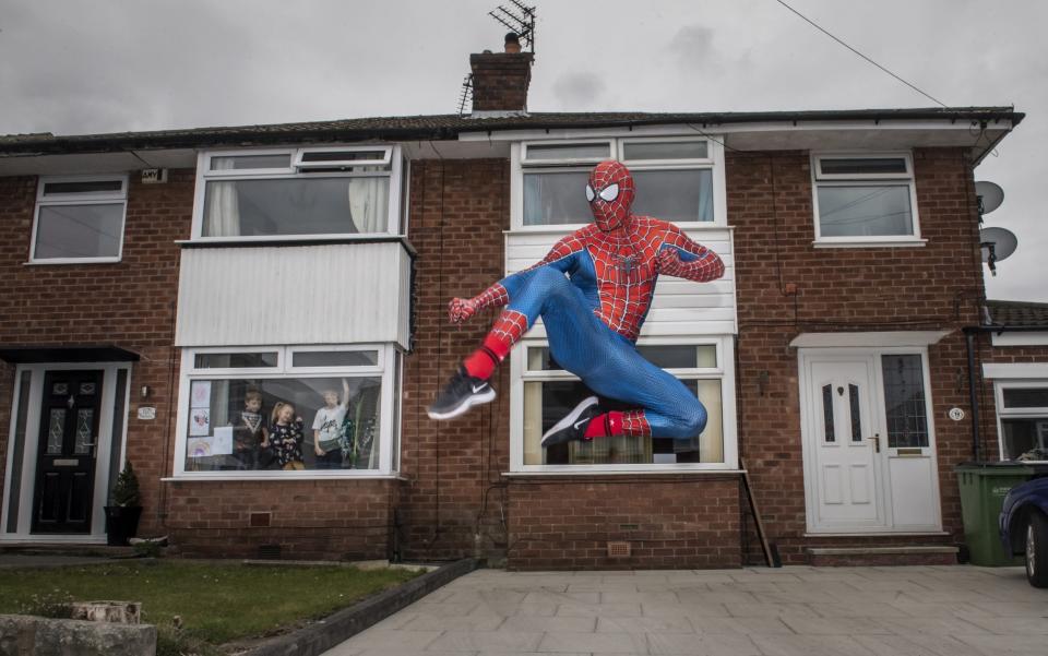 Jason Baird dressed as Spider-Man walks the streets of Bredbury to cheer-up children self isolating at home - Anthony Devlin/Getty Images