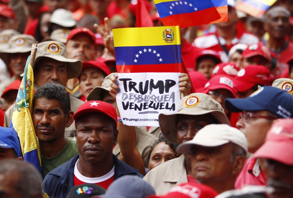 Members of the Bolivarian militia attend a protest against U.S. sanctions on Venezuela, in Caracas, Venezuela, Wednesday, Aug. 7, 2019. U.S. President Donald Trump signed an executive order Monday freezing Venezuelan government assets in the United States, allowing the Treasury Department to sanction any person, business or other entity assisting the administration of President Nicolas Maduro. (AP Photo/Leonardo Fernandez)