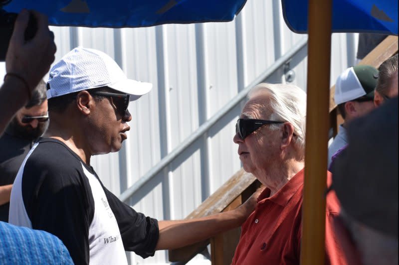 Republican presidential candidate Larry Elder speaks with a woman following an event with Iowa Gov. Kim Reynolds at the Iowa State Fair in Des Moines on Thursday. Photo by Joe Fisher/UPI
