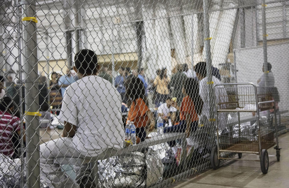 People who have been taken into custody related to cases of illegal entry into the United States sit in one of the cages at a facility in McAllen, Texas, Sunday, June 17, 2018. (Photo: U.S. Customs and Border Protection's Rio Grande Valley Sector via AP)