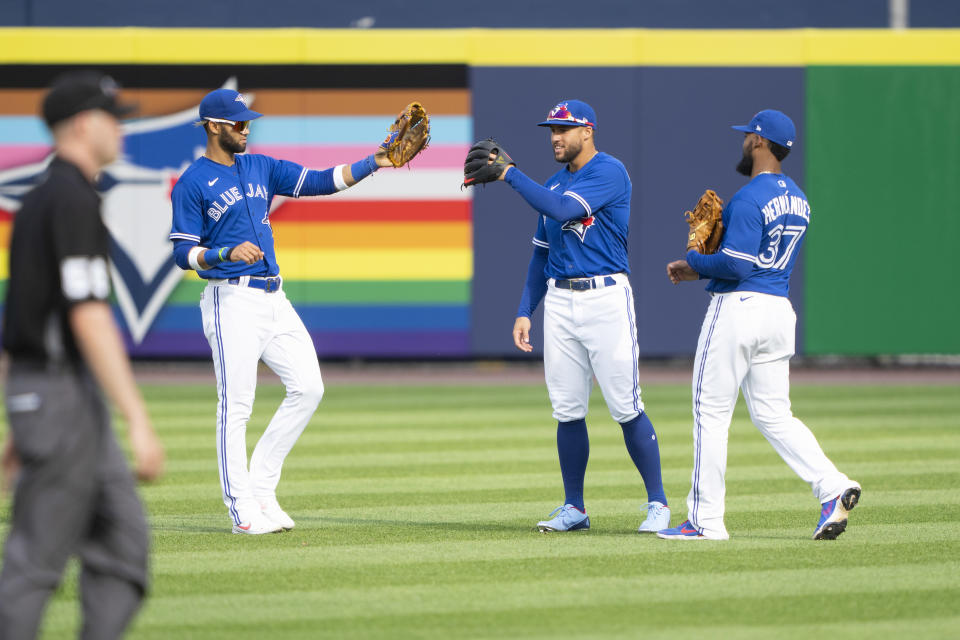 Jun 26, 2021; Buffalo, New York, CAN; Toronto Blue Jays left fielder Lourdes Gurriel Jr. (13) and Toronto Blue Jays center fielder George Springer (4) and Toronto Blue Jays right fielder Teoscar Hernandez (37) celebrate the victory after the ninth inning against the Baltimore Orioles at Sahlen Field. Mandatory Credit: Gregory Fisher-USA TODAY Sports