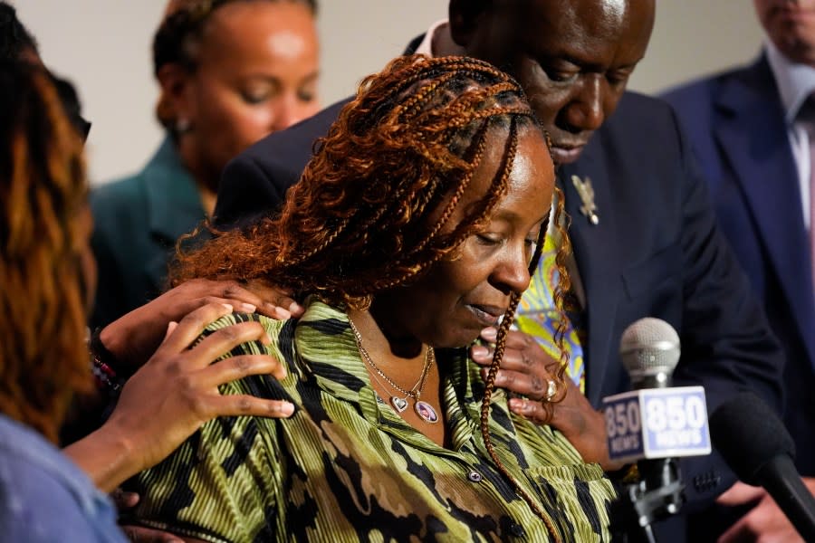 CORRECTS SERVICE BRANCH TO U.S. AIR FORCE INSTEAD OF U.S. NAVY – Chantemekki Fortson, mother of Roger Fortson, a U.S. Air Force senior airman, is comforted as she speaks about her son during a news conference regarding his death, with attorney Ben Crump, behind, Thursday, May 9, 2024, in Fort Walton Beach, Fla. Fortson was shot and killed by police in his apartment, May 3, 2024. (AP Photo/Gerald Herbert)