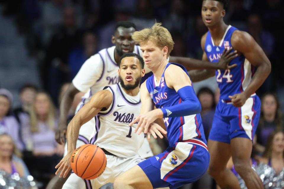 Kansas State's Markquis Nowell (1) pressures Kansas' Gradey Dick (4) during the first half of the Sunflower Showdown at Bramlage Coliseum on Jan. 17. Dick leads the Big 12 in 3-point percentage at 43.7. But during the Jayhawks' three-game losing streak, he's made only 23.8% (5-for-21) of his attempts.