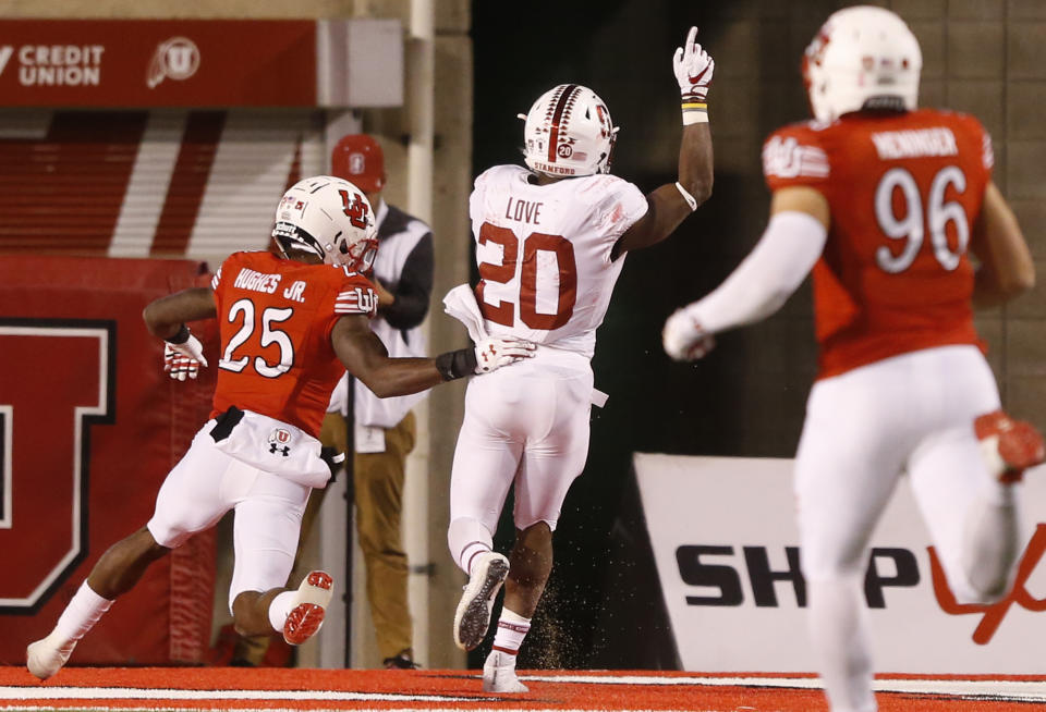 Stanford running back Bryce Love (20) scores a touchdown as Utah defensive back Casey Hughes (25) looks on in the second half during an NCAA college football game Saturday, Oct. 7, 2017, in Salt Lake City. (AP Photo/Rick Bowmer)