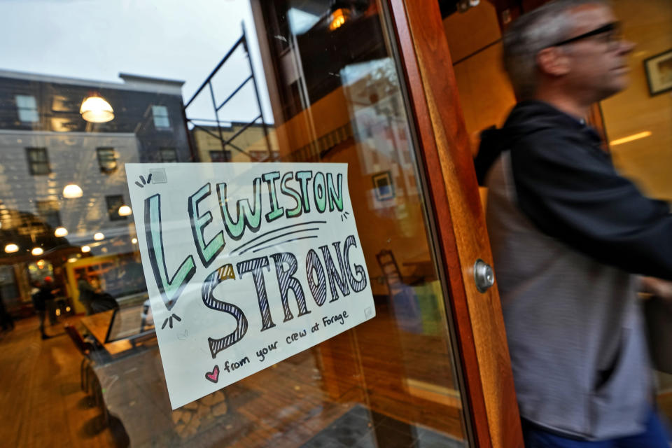 A customer exits a coffee shop, Monday, Oct. 30, 2023, in Lewiston, Maine. Residents of Lewiston returned to work Monday, the morning after coming together to mourn those lost in Maine's worst mass shooting. Investigators are still searching for a motive for the massacre that claimed 18 people at a bowling alley and a bar in Lewiston on Wednesday, Oct 25 as the community seeks a return to normalcy. (AP Photo/Matt York)