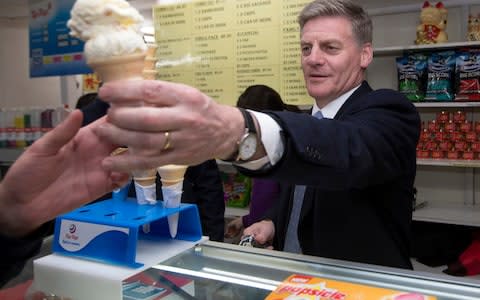 New Zealand Prime Minister Bill English serves ice creams for supporters in Pokeno, New Zealand, Friday, September 22 - Credit: Mark Mitchell/New Zealand Herald via AP