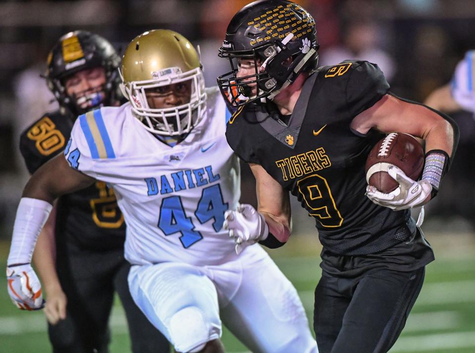 Crescent senior Reece Binniger (9) runs near DW Daniel junior Jaedyn Young (44) during the second quarter at Crescent High in Iva, S.C. Friday, October 28, 2022.