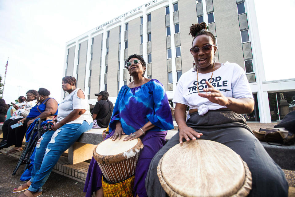 Vicki Goldston, center, and LaQuanda Simpson, right, play African drums (Dan Busey / The Times Daily / AP)