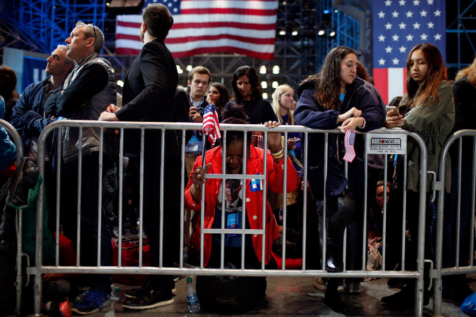 Marta Lunez prays on her knees as election results come in at Democratic presidential nominee former Secretary of State Hillary Clinton's election night event at the Jacob K. Javits Convention Center on Nov. 9, 2016.