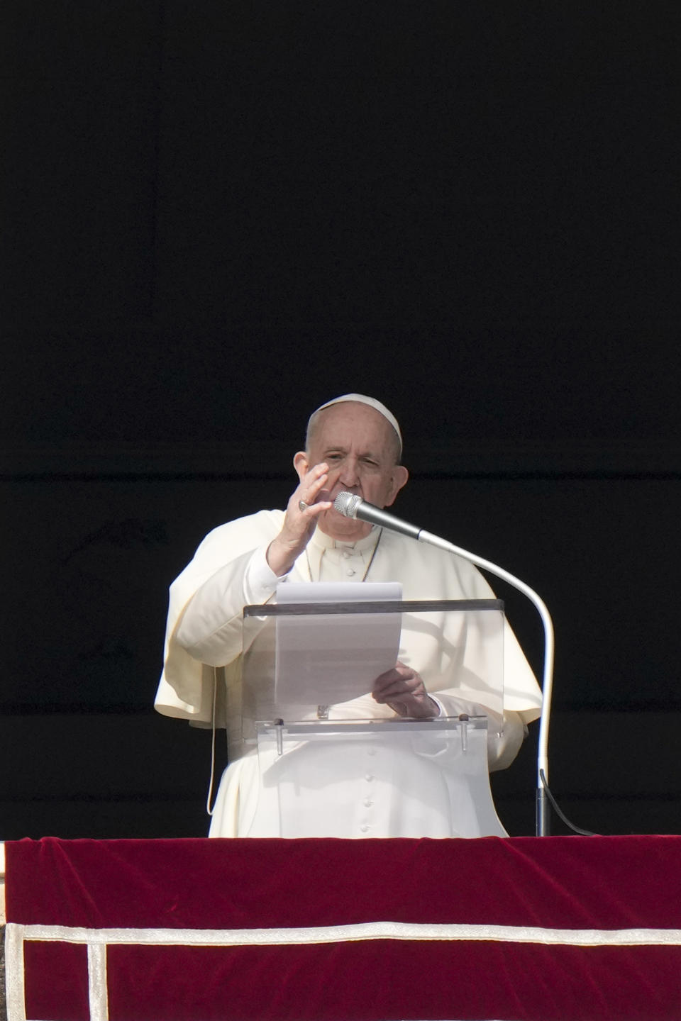 Pope Francis delivers his blessing as he recites the Angelus noon prayer from the window of his studio overlooking St.Peter's Square, at the Vatican, Sunday, Jan. 23, 2022. (AP Photo/Andrew Medichini)