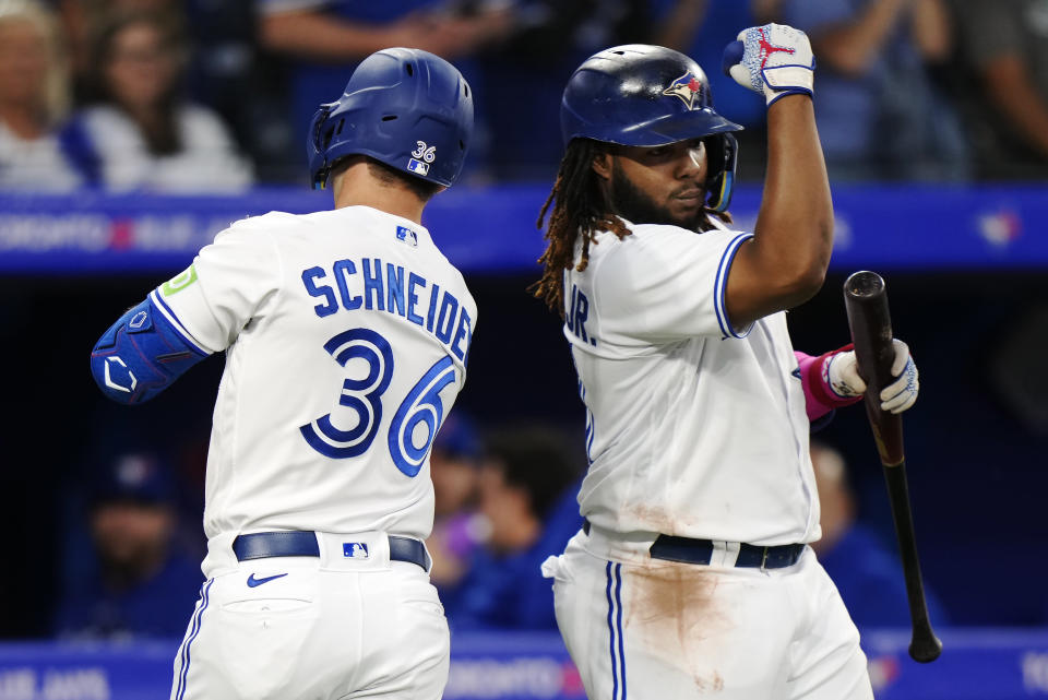 Toronto Blue Jays' Davis Schneider (36) celebrates his solo home run against the Washington Nationals with Vladimir Guerrero Jr. during the third inning of a baseball game Tuesday, Aug. 29, 2023, in Toronto. (Frank Gunn/The Canadian Press via AP)