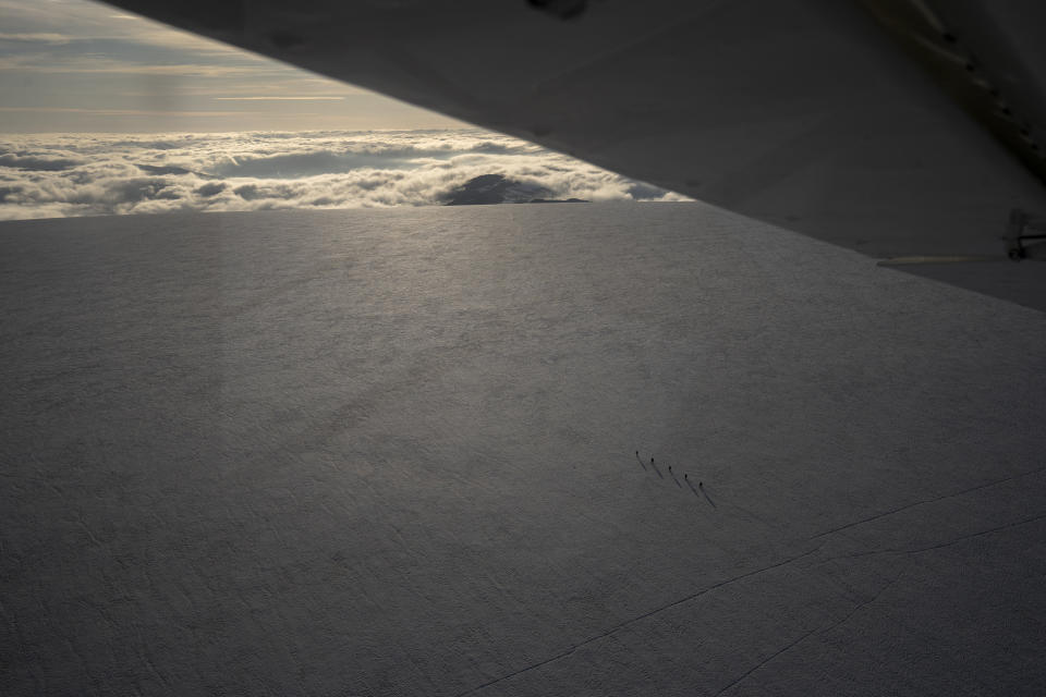 People hike on top of a glacier in Norway, on July 29, 2022, seen from Garrett Fisher's plane. (AP Photo/Bram Janssen)