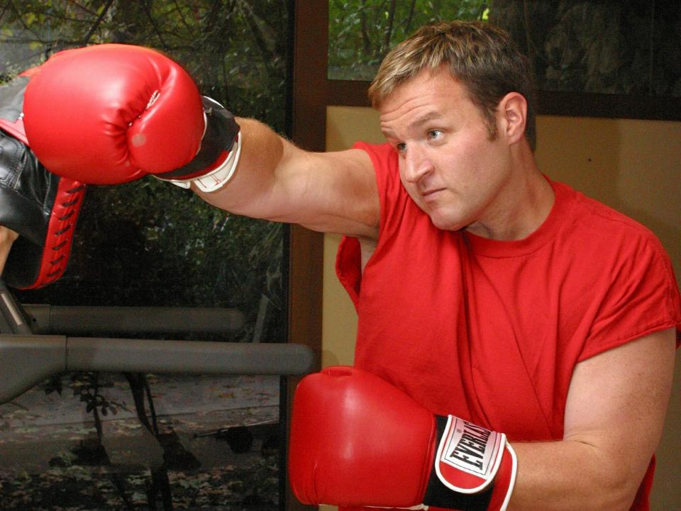 Ryan boxing in a red shirt and red boxing gloves.