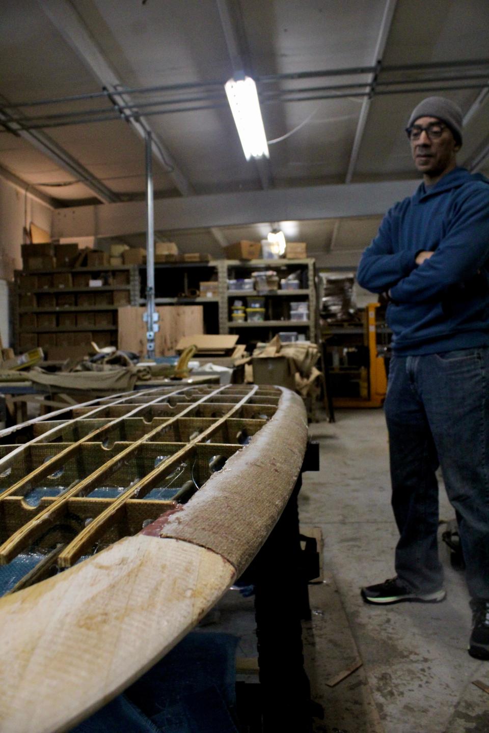 Ken Cole ponders what he should inscribe inside the board before they seal the belly on.