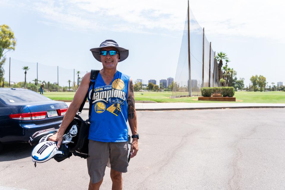 Robert Pamiroyan carries his golf bag after shooting at the driving range at the Encanto Golf Course in Phoenix on Wednesday, July 24, 2024. The heat wasn’t bad and it’s “the best time to play golf” because there’s “nobody out there,” Pamiroyan said. The temperature at 11:20 a.m. was about 97 degrees.