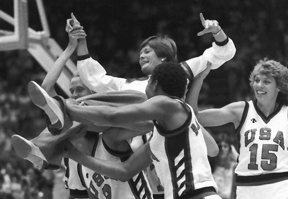 FILE - U.S. women's basketball coach Pat Summitt is carried by members of the team following their 85-55 gold medal win against South Korea, at the Olympic Games in Los Angeles, Aug. 8, 1984. Also shown are players Cathy Boswell, foreground right, and Carol Menken-Schaudt (15). (AP Photo/Dave Tenenbaum, File)