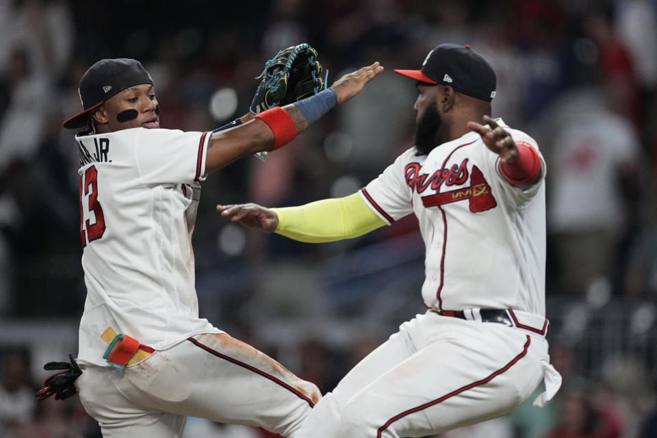 Atlanta Braves Ronald Acuna Jr., left, and Marcell Ozuna celebrate after defeating the Philadelphia Phillies in a baseball game Tuesday, Sept. 19, 2023. (AP Photo/John Bazemore)