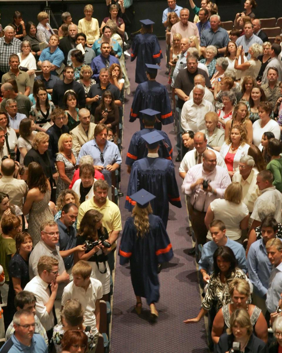 Family and friends attend the commencement ceremony for high school graduates.