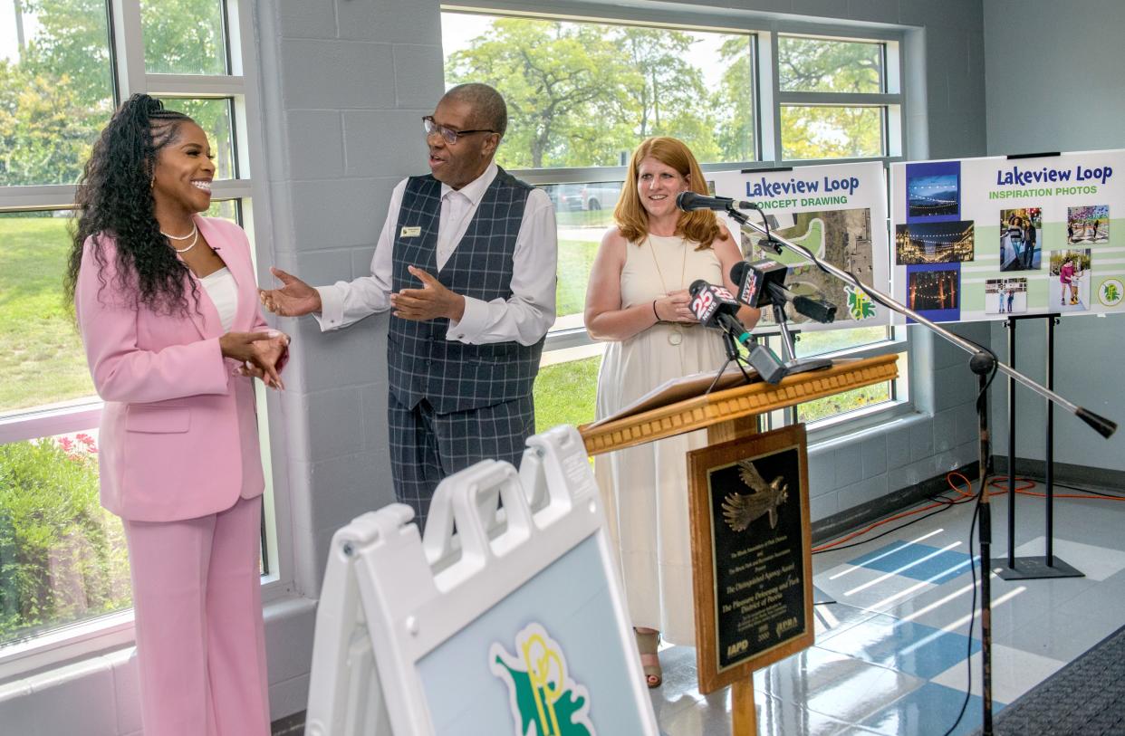 Peoria Park District board president Robert Johnson, middle, and executive director Emily Cahill, right, join in singing "Happy Birthday" to State Rep. Jehan Gordon-Booth during a press conference celebrating the new Lakeview Loop outdoor roller-skating facility planned for Lakeview Park and future upgrades to Donovan Park on Wednesday, Aug 23, 2023 at the Lakeview Recreation Center in Peoria.