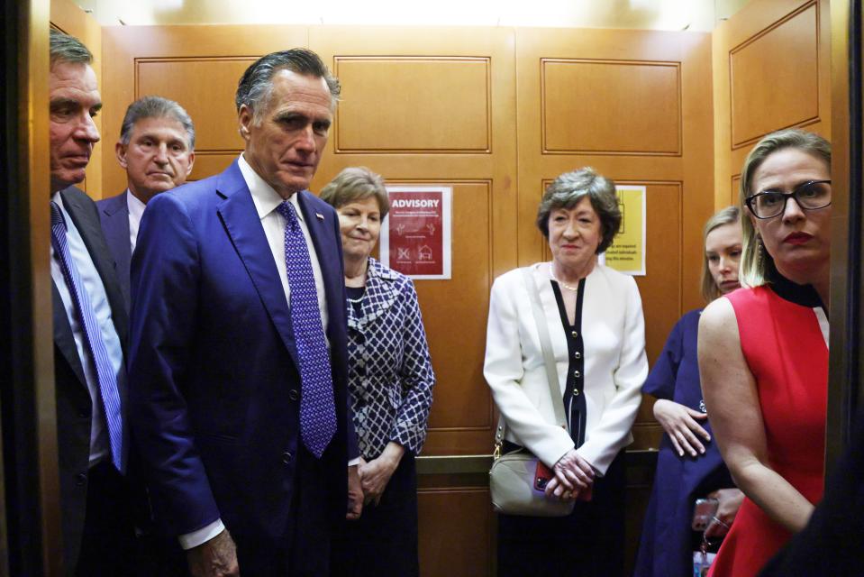 Sens. Mark Warner, D-Va., Joe Manchin, D-W.Va., Mitt Romney, R-Utah,, Jeanne Shaheen, D-N.H., Susan Collins, R-Maine, and Kyrsten Sinema, D-Ariz., take a break from a meeting on infrastructure for going to a vote at the U.S. Capitol on Tuesday.