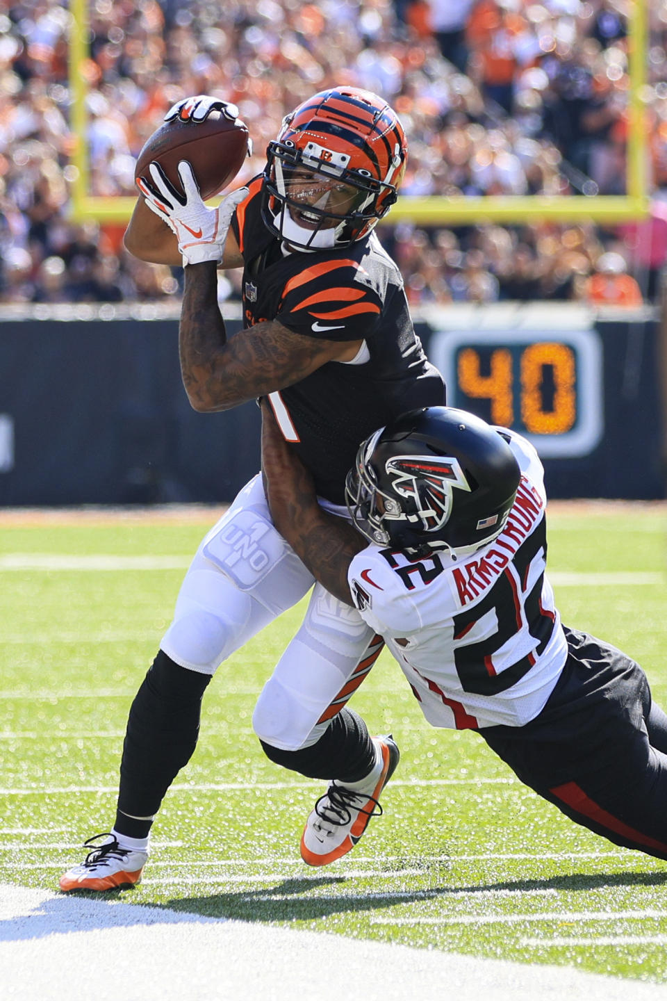 Cincinnati Bengals wide receiver Ja'Marr Chase (1) is tackled by Atlanta Falcons cornerback Cornell Armstrong in the first half of an NFL football game in Cincinnati, Sunday, Oct. 23, 2022. (AP Photo/Aaron Doster)