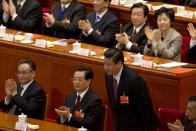 FILE - In this March 14, 2013, file photo, Chinese President Xi Jinping bows next to his predecessor Hu Jintao, center, after Xi was elected as president at a plenary session of the National People's Congress held at the Great Hall of the People in Beijing. (AP Photo/Ng Han Guan, File)