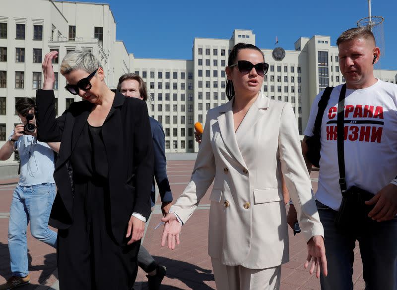 FILE PHOTO: Presidential candidate Svetlana Tikhanouskaya and representative of politician Viktor Babariko's campaign office Maria Kolesnikova walk in Minsk