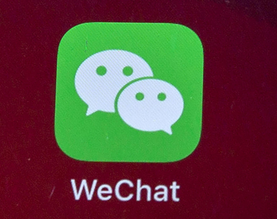 FILE - Icons for the smartphone apps WeChat are seen on a smartphone screen in Beijing, on Aug. 7, 2020. The Justice Department is asking a judge to allow WeChat to be banned from app stores in the U.S., pending an appeal. In a Friday, Sept. 25, 2020 filing, the Justice Department requested U.S. Magistrate Judge Laurel Beeler in California put on hold a preliminary injunction issued Saturday. (AP Photo/Mark Schiefelbein, File)