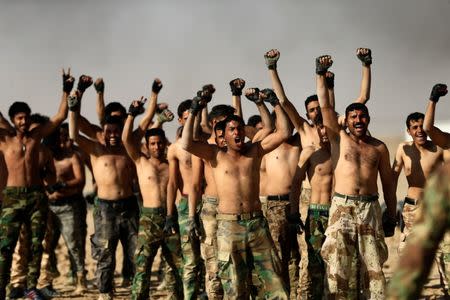 Sunni volunteers, who have joined the Abbas Fighting Division, shout slogans after a field training in Kerbala, Iraq December 20, 2017. Picture taken December 20, 2017. REUTERS/Thaier Al-Sudani