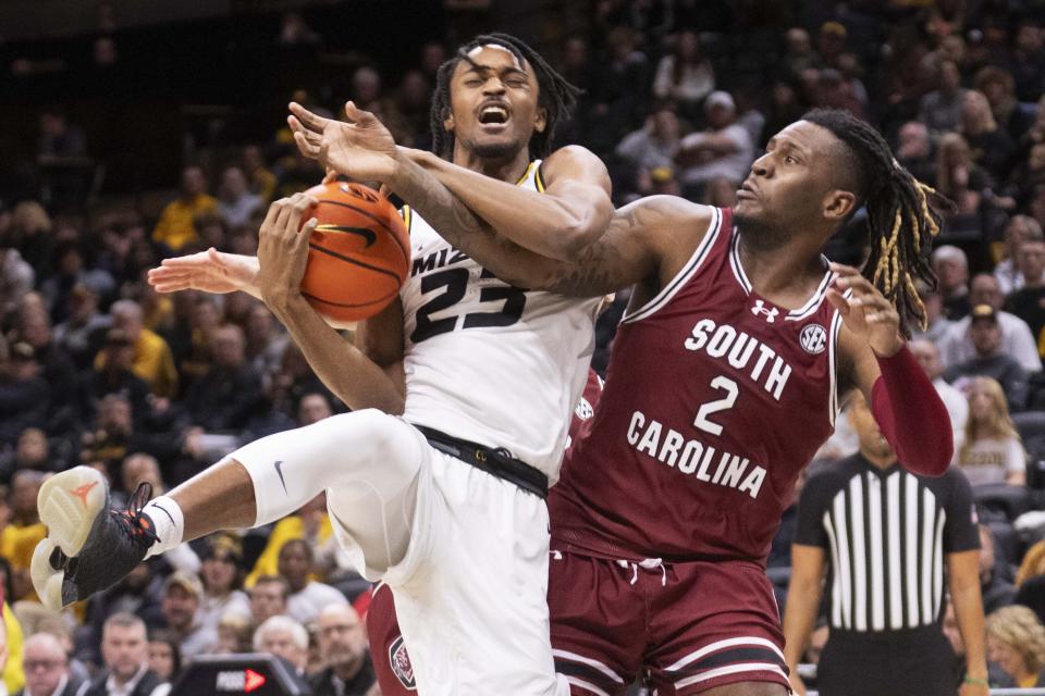 Missouri's Aidan Shaw, left, and South Carolina's B.J. Mack, right, battle for a rebound during the second half of an NCAA college basketball game Saturday, Jan. 13, 2024, in Columbia, Mo. South Carolina won 71-69 in overtime. (AP Photo/L.G. Patterson)