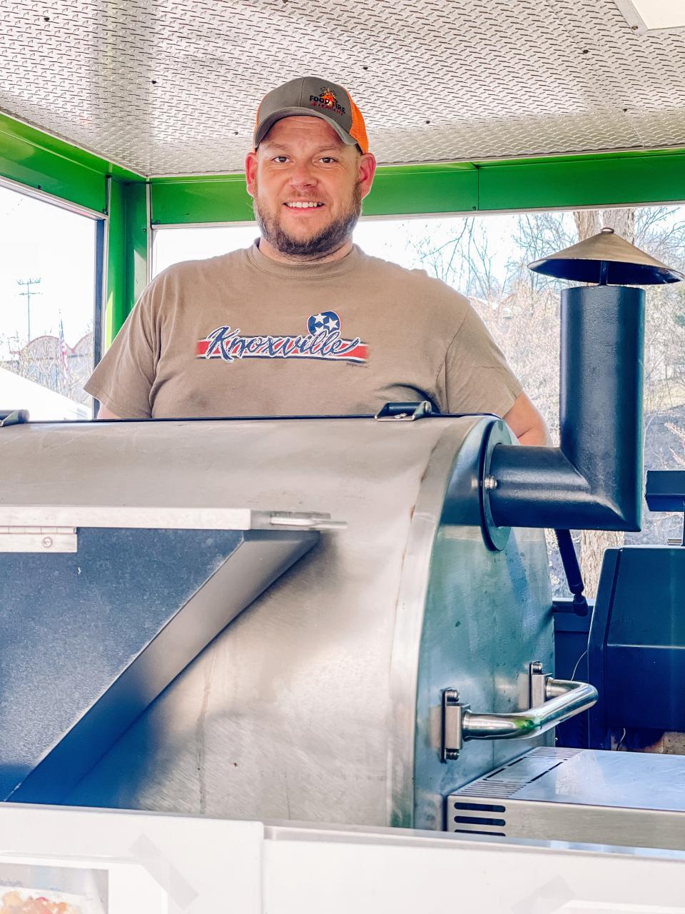 Jesse Thompson of Halls, owner of Food Fire and Ferment food truck, serves lunch at the Regal headquarters in South Knoxville on March 4, 2022.