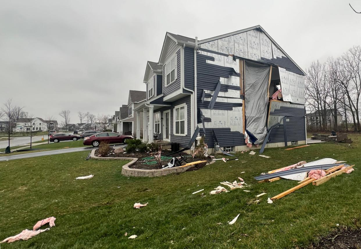 Damage is seen to houses in The Pines at Berlin Station subdivision in Lewis Center, Delaware County, on Friday morning after severe storms ripped through Central Ohio overnight.