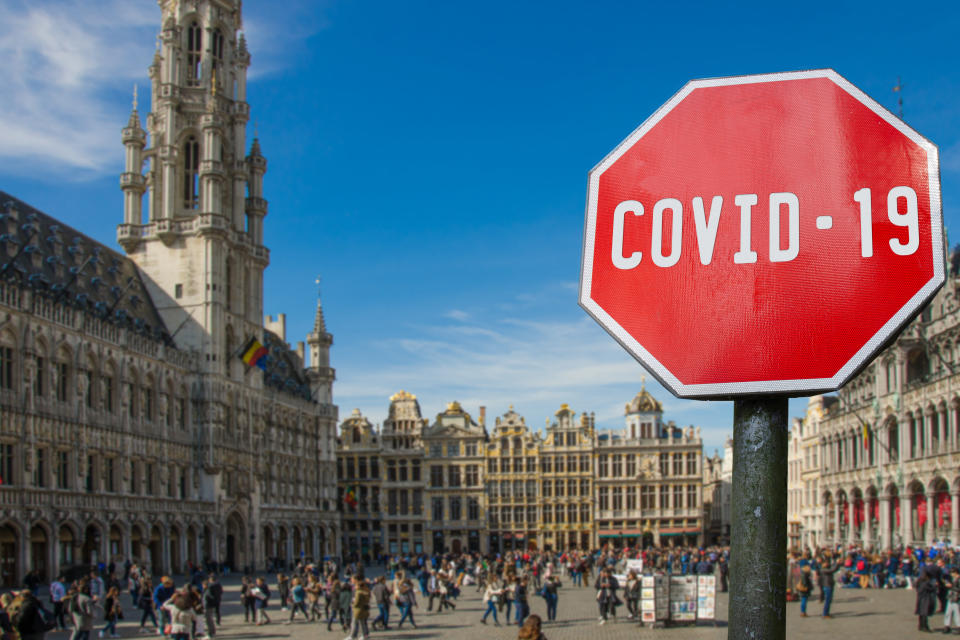 COVID-19 sign against view of Grand Place (Grote Markt) in Brussels, Belgium. Warning about pandemic in Croatia. Coronavirus disease. COVID-2019 alert sign