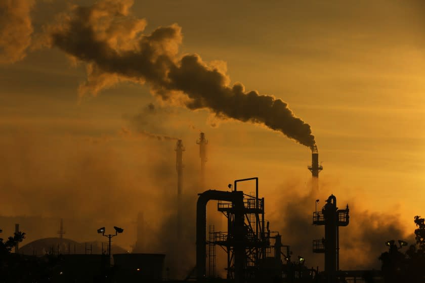 Environmentalists in Washington are hoping to lead the way with a proposed carbon tax. California has gone in a different direction with a cap-and-trade rule, which impact facilities like this refinery in Wilmington.