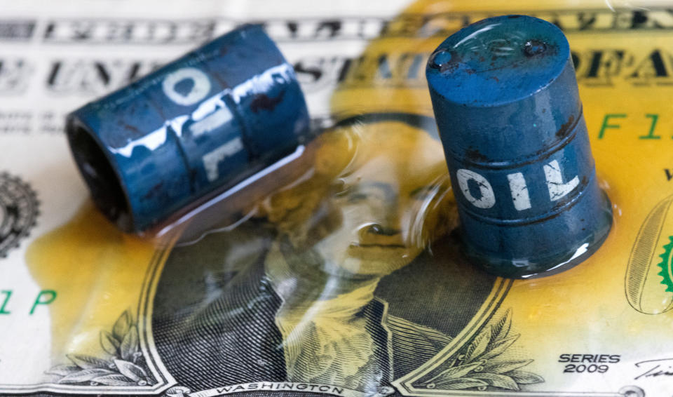 Oil, miniatures of oil barrels and U.S. dollar banknote are seen in this illustration taken, June 6, 2023. REUTERS/Dado Ruvic/Illustration