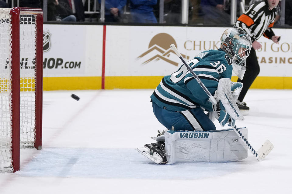 San Jose Sharks goaltender Kaapo Kahkonen gives up a goal to Colorado Avalanche center Nathan MacKinnon during overtime in an NHL hockey game Tuesday, April 4, 2023, in San Jose, Calif. (AP Photo/Tony Avelar)