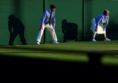 Tennis - Wimbledon - All England Lawn Tennis and Croquet Club, London, Britain - July 5, 2018. Match officials watch play as Belgium's Alison Van Uytvanck plays her second round match against Spain's Garbine Muguruza . REUTERS/Toby Melville