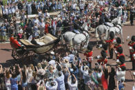 <p>A horse-drawn carriage lead the way for the royal couple as they left the church. (Photo: Getty) </p>