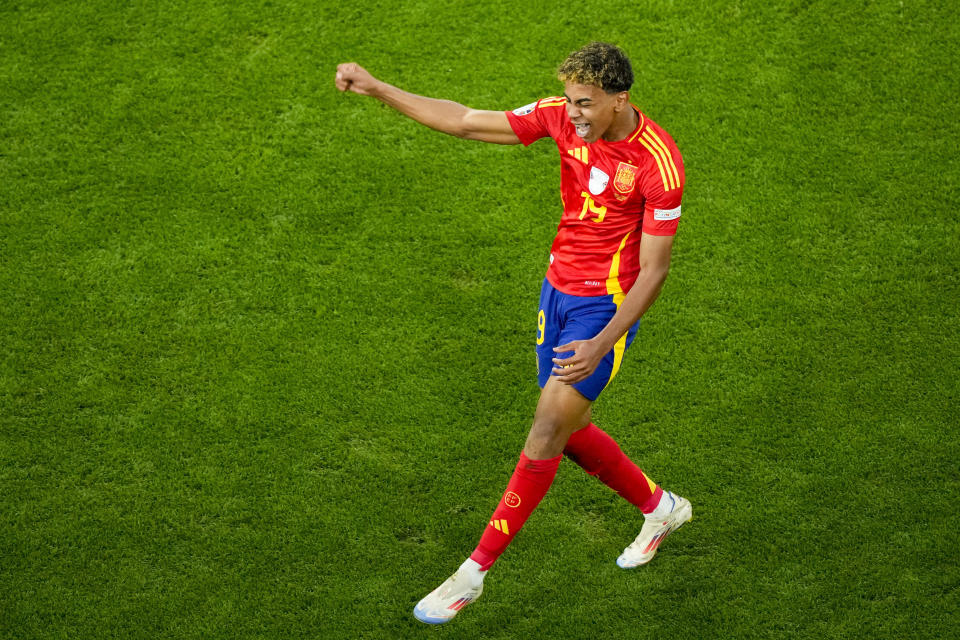 Spain's Lamine Yamal celebrates scoring his side's first goal during a semifinal match between Spain and France at the Euro 2024 soccer tournament in Munich, Germany, Tuesday, July 9, 2024. (AP Photo/Ebrahim Noroozi)