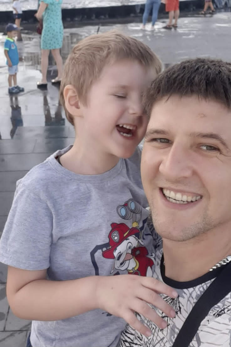 This pre-war photo provided by the family shows 5-year-old Artem Erashov, with his father, Volodymyr. The boy and his 7-year-old cousin, Angelina, were killed during Russian shelling on March 9, 2022. The families of the young cousins returned to occupied Mariupol to rebury their children in the Staryi Krym cemetery, now the site of thousands of new graves since the Russian invasion began Feb. 24. (Family photo via AP)