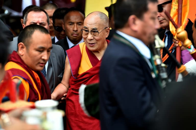 The Dalai Lama (C) arrives to address tje faithful on June 29, 2015 in Aldershot, which has a large Nepalese Buddhist community made up mainly of serving and retired Gurkha soldiers