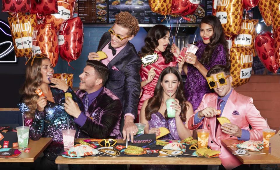 An after-prom party at Taco Bell with seven well-dressed attendees.