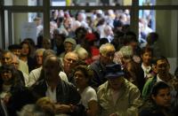 People queue to cast their ballots at a polling station in Massama on the outskirts of Lisbon on October 4, 2015