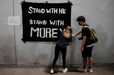Protesters hang a banner during a gathering in support of NBA's Houston Rockets' team general manager Daryl Morey, who sent a tweet backing the pro-democracy movement, in Hong Kong