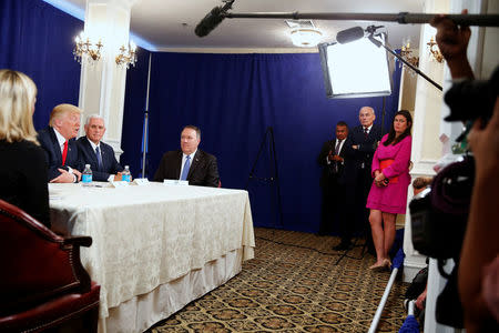 White House Chief of Staff John Kelly (2nd R) and White House Press Secretary Sarah Huckabee Sanders (R) look on from the wings as U.S. President Donald Trump (L) speaks to reporters after a security briefing with Vice President Mike Pence (2nd L) and Central Intelligence Agency (CIA) Director Mike Pompeo (3rd L) at Trump's golf estate in Bedminster, New Jersey U.S. August 10, 2017. REUTERS/Jonathan Ernst