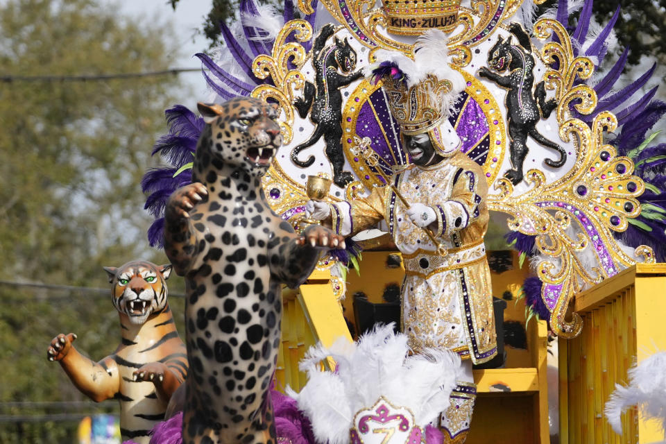 King of Zulu Nick Spears rides on a float during the traditional Krewe of Zulu Parade on Mardi Gras Day in New Orleans, Tuesday, Feb. 21, 2023. (AP Photo/Gerald Herbert)