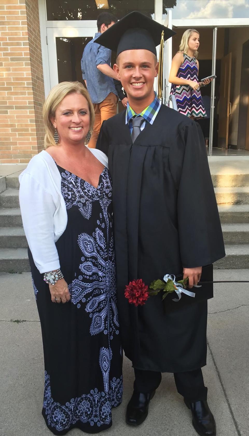 18-year-old Colton Wright stands next his mom, Amy Thompson, following his high school graduation in May 2016.